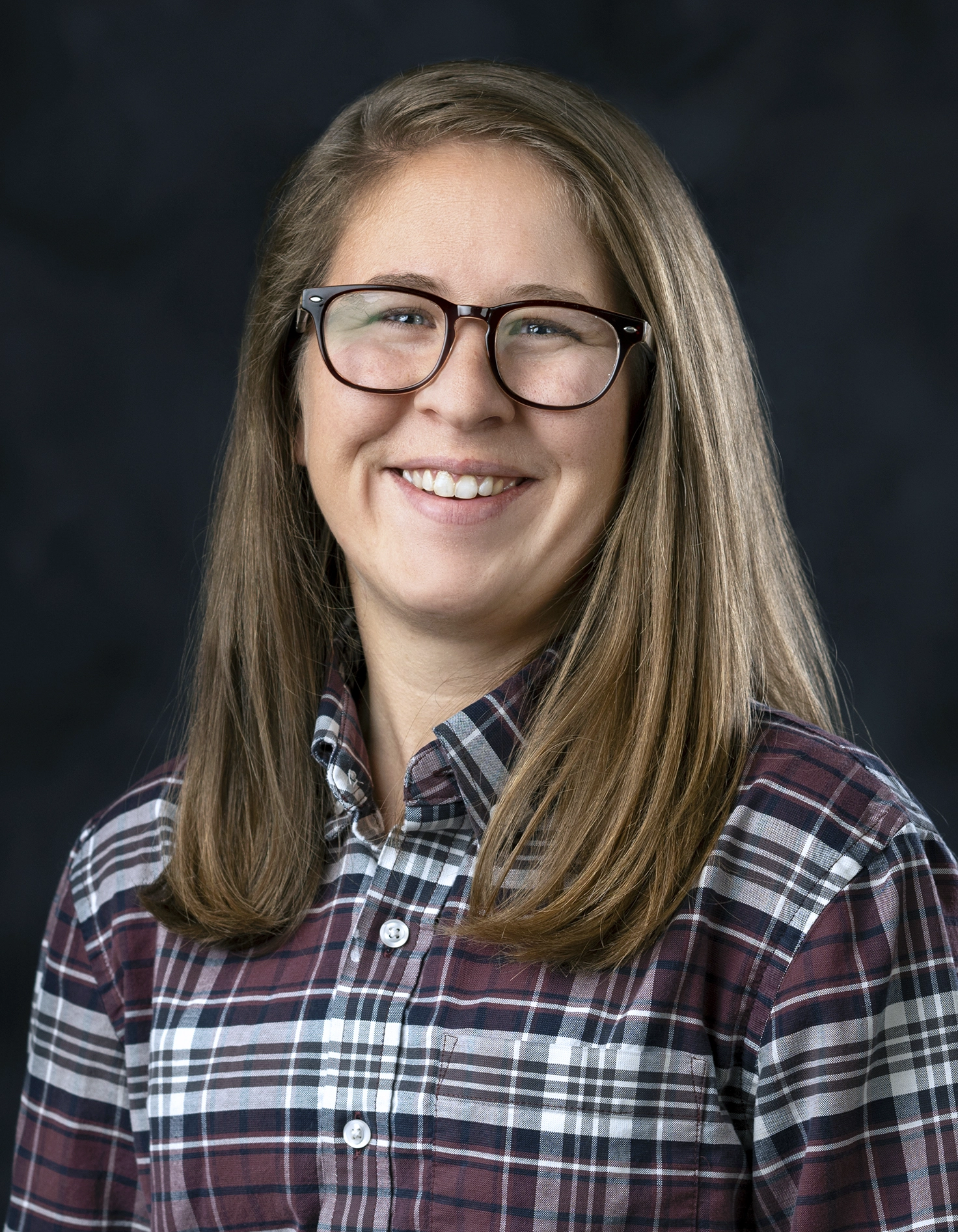 Formal studio headshot portrait of Mary Pollitz